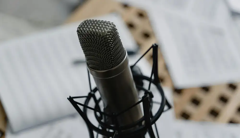 Hero Image: Microphone with Scripts on table